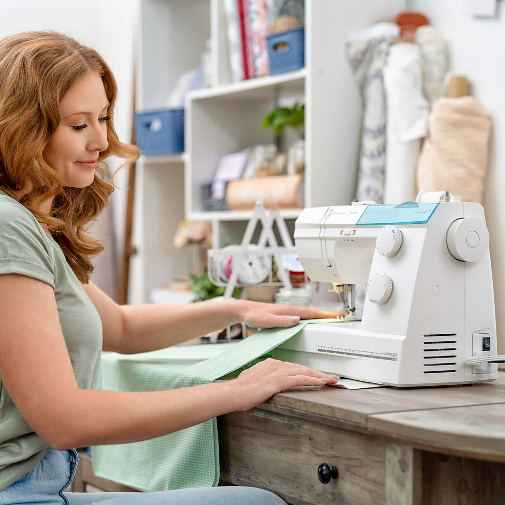 Woman sewing with an Emerald 118